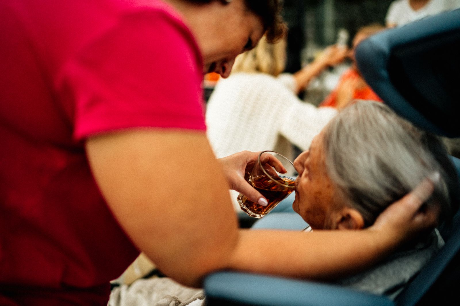 A BestaCare caretaker helping an elderly patient at home